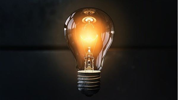Electric light bulb on dark background