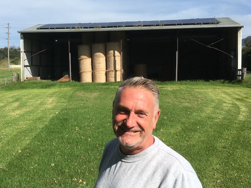 Simon Milner posing with his 10kw solar panel system